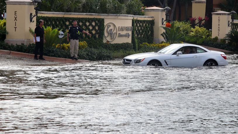 A car broke down on State Road A1A in Manalapan, Florida, with the roads flooded from Hurricane Nicole on Thursday, Nov. 10, 2022. Nicole has since been downgraded to a Tropical Storm as it churns across the state. (Mike Stocker/South Florida Sun-Sentinel/TNS)