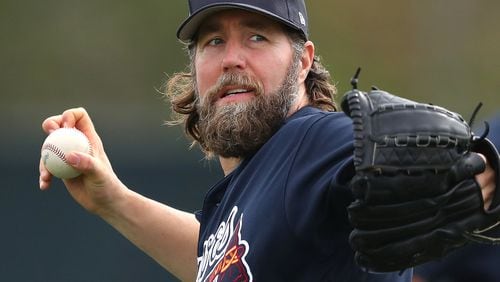 Braves pitcher R.A. Dickey sets free another butterfly — what he calls throwing a knuckleball — during spring training. (Curtis Compton/ccompton@ajc.com)
