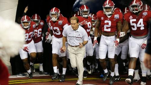 In this Saturday, Dec. 31, 2016, photo, Alabama head coach Nick Saban and players enter the field for the first half of the Peach Bowl NCAA college football playoff game against Washington in Atlanta. The system of core beliefs, this daily guidebook for going about your business, has carried Saban and Alabama to the brink of yet another national championship. Call it The Process. Call it the Saban Way. It's hard to call it anything but successful. (AP Photo/John Bazemore)