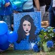 A painting of 15-year-old Mia Dieguez is seen before a balloon release at Brook Run Park in Dunwoody on Wednesday. The Dunwoody High School student died after a medical emergency Monday.