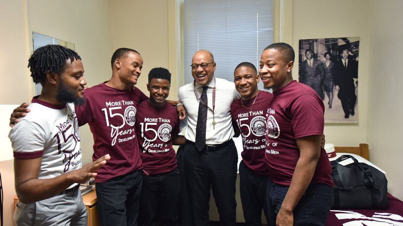 Morehouse President David A. Thomas shares a laugh with Wendell Shelby-Wallace (left), VP of the Student Government Association, and RAs (from second from left) Marcus Washington, MarKuan Tigney Jr., David Jeffries and Kayden Molock after he moved into his room at historic Graves Hall in Morehouse College on Aug. 7. HYOSUB SHIN / HSHIN@AJC.COM