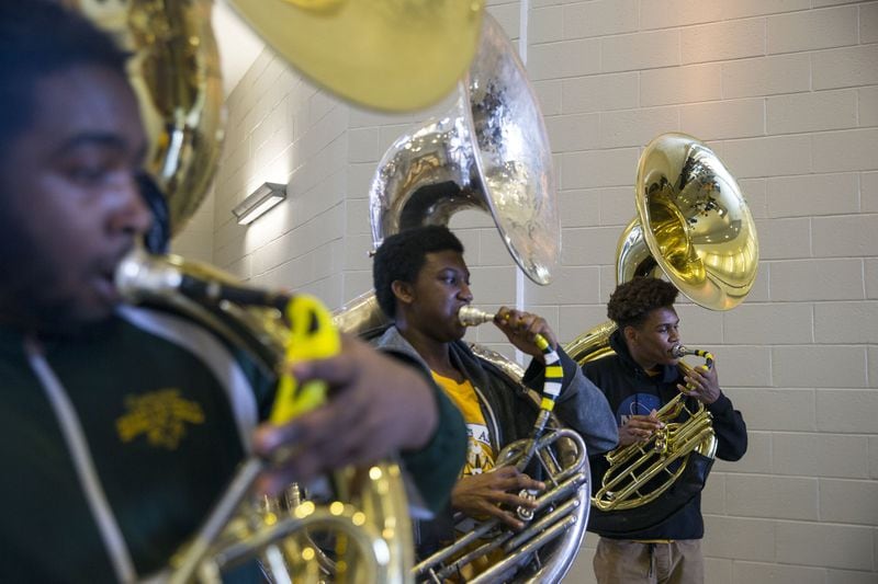 Douglass High School marching band tuba section leader Stephon Wheeler, right, plays with members of his section while practicing for their upcoming Mardi Gras show. The band showed interest in playing during Mardi Gras in New Orleans but was unable to come up with the funds to go. Wheeler took to social media and asked Douglass High alumni and local Atlanta rapper Killer Mike, to donate. Killer Mike donated and enlisted the help of other entertainment stars. ALYSSA POINTER/ALYSSA.POINTER@AJC.COM