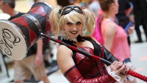A cosplay fan dressed as Harley Quinn from Batman joins the Dragon Con parade in 2016.