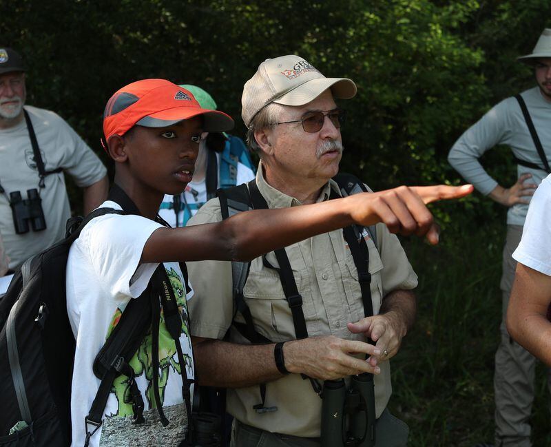 Camper Tadsse Owens points out a bird to Bob Sargent, Georgia Department of Natural Resources, during a Camp TALON visit to Harris Neck National Wildlife Refuge on Tuesday, June 6, 2023.
