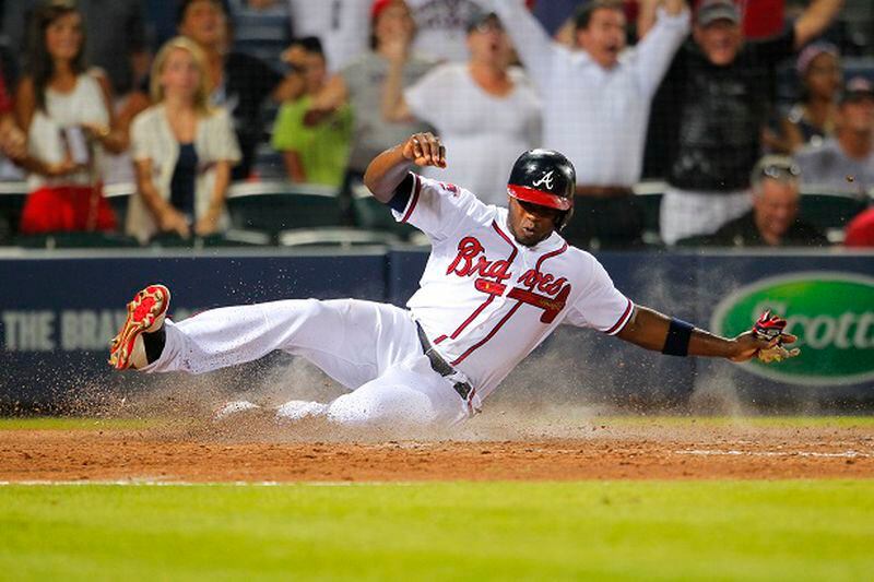 Atlanta Braves Justin Upton (8) slides in to score in the ninth inning of a baseball game against the Philadelphia Phillies Monday, June 16, 2014, in Atlanta. (AP Photo/Todd Kirkland) Here's proof that the Braves did score a run Monday. (Todd Kirkland/AP)