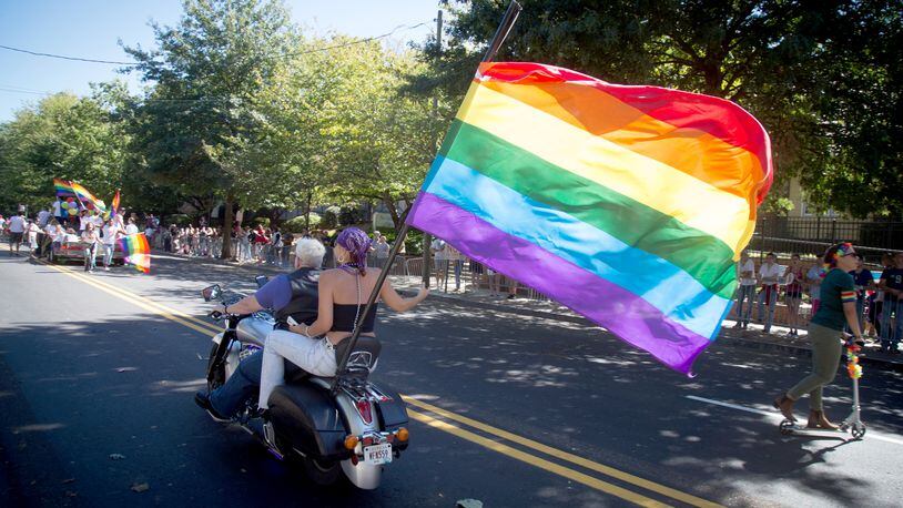 A motorcycle with a large rainbow flag heads up 10th Street during the Atlanta Pride Parade in this October 2016 file photo.