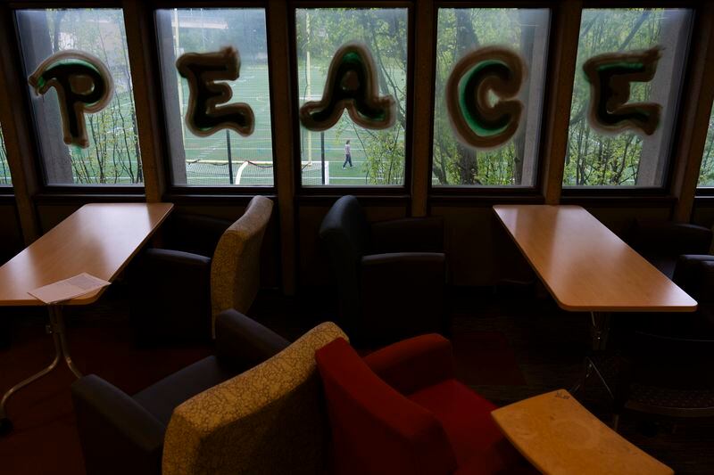 The word "Peace" written by a anti-war protesters is displayed on the windows at Millar Library at Portland State University, Wednesday, May 1, 2024, in Portland, Ore. (AP Photo/Jenny Kane)