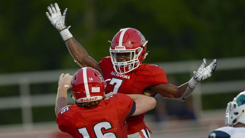 Buccaneers running back Alex Wilson (7) celebrates with tight end Jay Ellison (16) after Ellison scores a touchdown early in the first half of their game at Allatoona High Friday, September 6, 2019. (Daniel Varnado/Special)