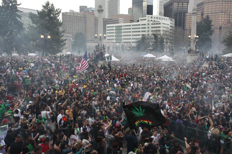 FILE - Members of a crowd numbering tens of thousands smoke marijuana and listen to live music at the Denver 420 pro-marijuana rally at Civic Center Park in Denver, April 20, 2013. Marijuana advocates are gearing up for Saturday, April 20, 2024. Known as 4/20, marijuana's high holiday is marked by large crowds gathering in parks, at festivals and on college campuses to smoke together. This year, activists can reflect on how far the movement has come. (AP Photo/Brennan Linsley, File)