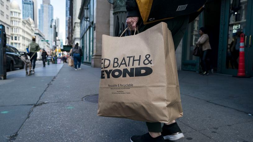 A shopper carries a Bed Bath & Beyond bag outside the company’s store in the Chelsea neighborhood of New York. The retailer filed for bankruptcy this week and is laying off 1,000 workers at its Jackson County distribution center. (Karsten Moran/The New York Times)