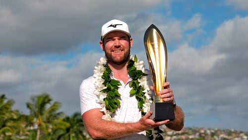 Grayson Murray holds the trophy after winning the Sony Open golf event, Sunday, Jan. 14, 2024, at Waialae Country Club in Honolulu. AP Photo/Matt York, File)