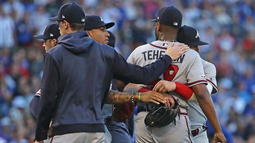 Players hold Julio Teheran during a brief altercation in the second inning of Monday's Braves-Cubs game at Wrigley Field. (Photo by Jonathan Daniel/Getty Images)