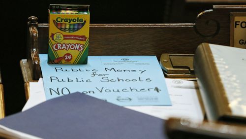 The teacher lobby had anti-school-voucher props placed on every lawmaker's desk before legislation came up for a vote. Vouchers are back in 2022 in the form of House Bill 999, which passed a House subcommittee Tuesday, Feb. 1.   (Bob Andres / bandres@ajc.com)