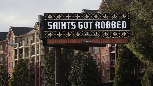 A digital billboard seen Tuesday on I-85 South at Peachtree Road in Atlanta reads “Saints Got Robbed” in reaction to the non-call on a pass interferance play by the Rams against the Saints in the NFC Championship Game . Curtis Compton/ccompton@ajc.com