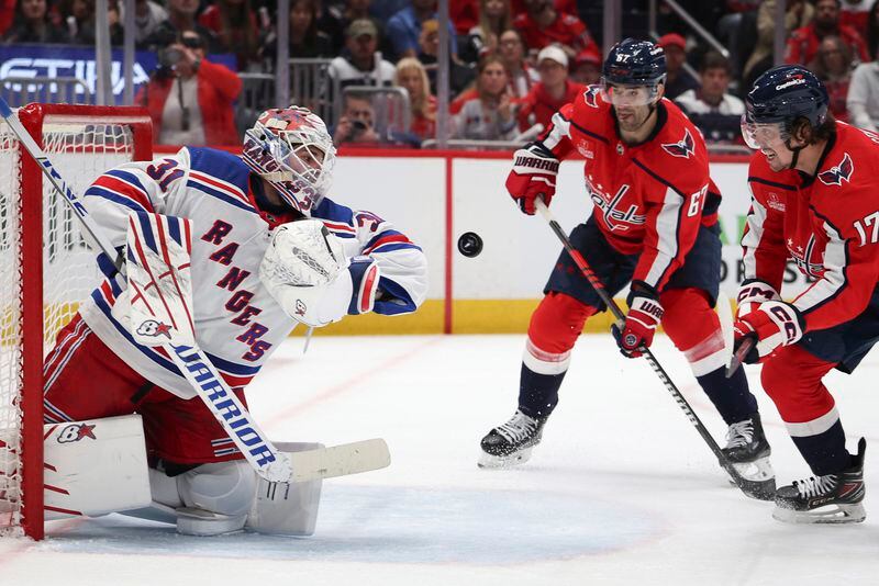 New York Rangers goaltender Igor Shesterkin (31) makes a save during the first period against the Wahington Capitals in Game 3 of an NHL hockey Stanley Cup first-round playoff series, Friday, April 26, 2024, in Washington. (AP Photo/Tom Brenner)