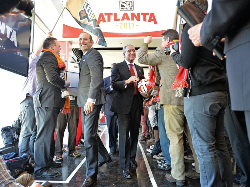 MLS commissioner Don Garber (center left) and Falcons owner Arthur Blank (center right) celebrated Atlanta’s MLS expansion franchise last month. The next task for the team is finding a president. HYOSUB SHIN / HSHIN@AJC.COM
