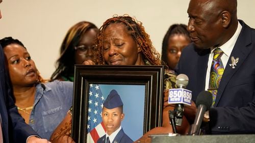 Chantemekki Fortson, mother of Roger Fortson, a U.S. Air Force senior airman, holds a photo of her son during a news conference regarding his death, with Attorney Ben Crump, right, Thursday, May 9, 2024, in Ft. Walton Beach, Fla. Fortson was shot and killed by police in his apartment on May 3, 2024. (AP Photo/Gerald Herbert)
