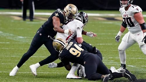Falcons quarterback Matt Ryan is sacked by Saints defensive ends Cameron Jordan (94) and Marcus Davenport, pushing the Falcons out of field goal range, in the first half Sunday, Nov. 22, 2020, in New Orleans. (Butch Dill/AP)