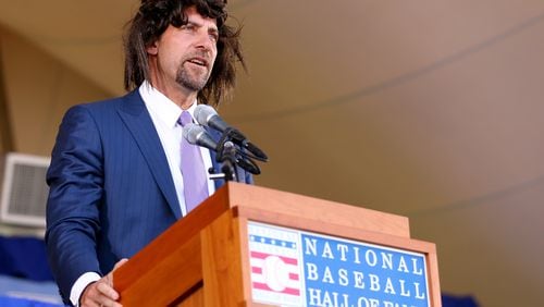 John Smoltz tries to relive his early days with hair as he speaks wearing a wig during the Hall of Fame induction ceremony for the Baseball Hall of Fame in Cooperstown, N.Y., on Sunday. Smoltz was inducted with Pedro Martinez,Craig Biggio and Randy Johnson. (Elsa/Getty Images)