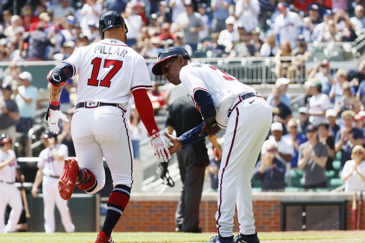 Braves left fielder Kevin Pillar shakes hand with third base coach Ron Washington after hitting a solo home run during the fifth inning against the Astros at Truist Park, Sunday, April 23, 2023, in Atlanta. 
 Miguel Martinez / miguel.martinezjimenez@ajc.com 