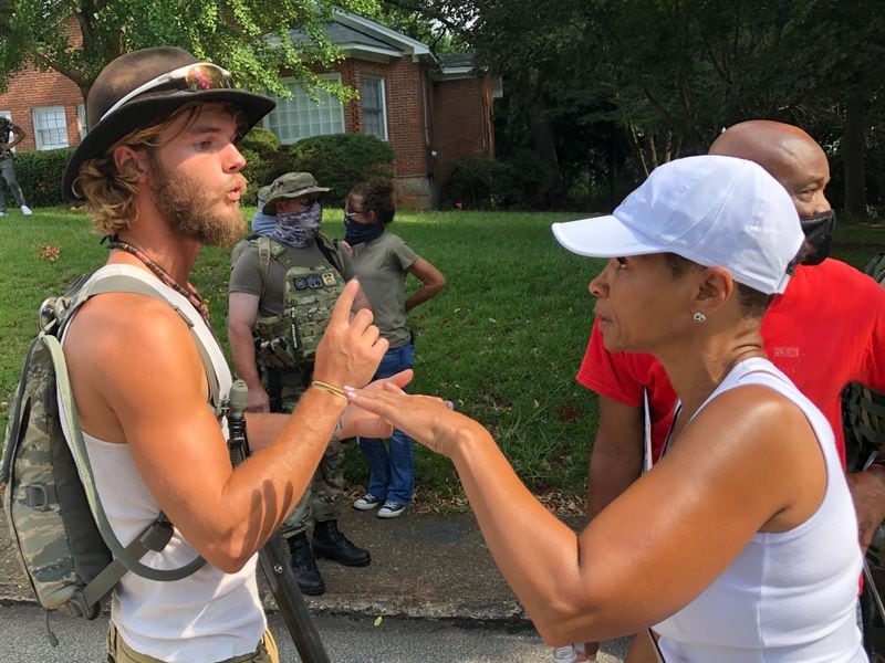 Saturday, Aug. 15, 2020, Stone Mountain -- Counterprotesters and militia members confront one another in Stone Mountain.