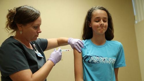 A nurse administers a dose of the HPV vaccine at an Illinois health clinic in 2018. The HPV vaccine, delivered as two or three doses, can significantly cut the risk of infection with HPV, which can cause cancer. (John J. Kim/Chicago Tribune/TNS)