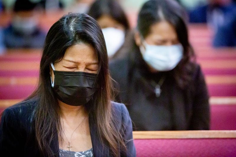 Soo Young Yoon bows her head during a prayer at the funeral for Daoyou Feng in Norcross on Sunday, April 4, 2021. (Photo: Steve Schaefer for The Atlanta Journal-Constitution)