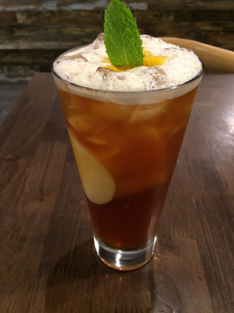 Among the flavored teas at Tea House Formosa is this delightful peach black tea. To many of the drinks at this trendy Buford Highway tea room, you may add custom toppings, such as boba, tea jelly or (shown here immersed in the glass) custard pudding. CONTRIBUTED BY WENDELL BROCK