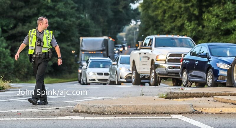 A Rockdale County deputy diverts traffic away from the chemical plant Monday morning.