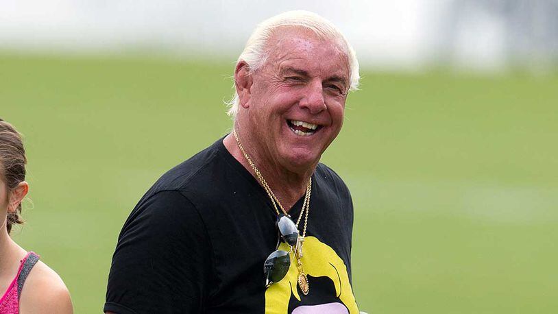 Pro wrestler 'Nature Boy' Ric Flair is all smiles during his visit to Falcons training camp Wednesday.