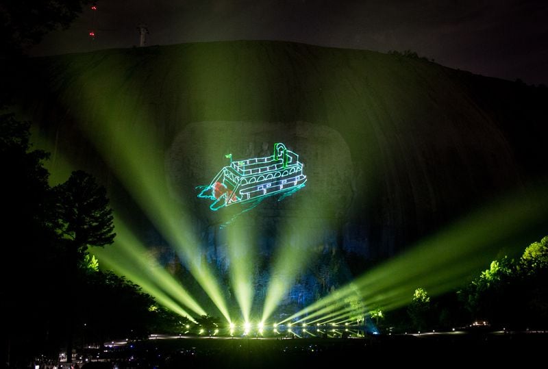 A paddle wheel boat appears on the side of Stone Mountain during a laser show. STEVE SCHAEFER / SPECIAL TO THE AJC