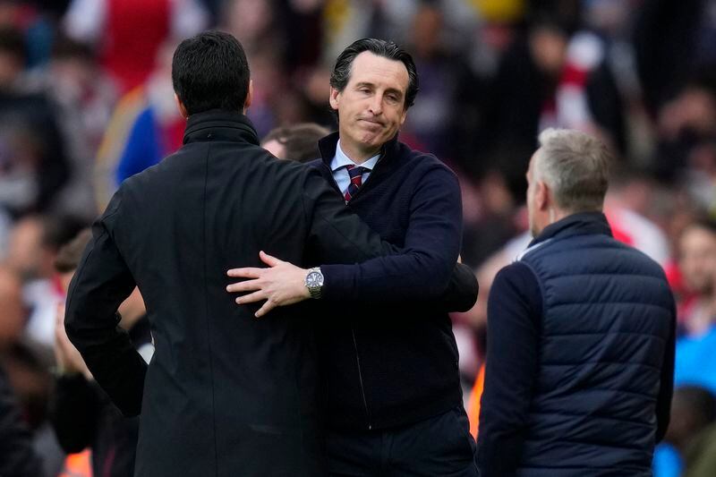 Aston Villa's head coach Unai Emery, right, hugs Arsenal's manager Mikel Arteta after the English Premier League soccer match between Arsenal and Aston Villa at the Emirates stadium in London, Sunday, April 14, 2024. (AP Photo/Kirsty Wigglesworth)