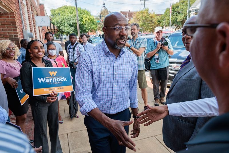Political perspective has a lot to do with how someone views today's economy. At a rally for Democratic U.S. Sen. Raphael Warnock, supporters were willing to give national policies more time to solve the problems of inflation. (Arvin Temkar/Atlanta Journal-Constitution/TNS)