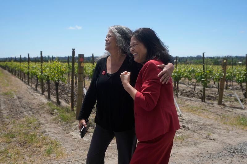 Acting United States Secretary of Labor Julie Su, right, walks with Teresa Romero, president of United Farm Workers, after a news conference at Balletto Vineyards in Santa Rosa, Calif., Friday, April 26, 2024. Temporary farmworkers workers are getting more legal protections against employer retaliation, unsafe working conditions, illegal recruitment and other abuses. The rule announced Friday by the Biden administration aims to bolster support workers on H-2A visas. (AP Photo/Jeff Chiu)