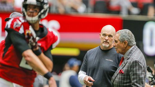 Atlanta Falcons head coach Dan Quinn talks with owner Arthur Blank (right) as the team warms up before a game against the Los Angeles Rams Sunday, Oct. 20, 2019, at Mercedes Benz Stadium in Atlanta.