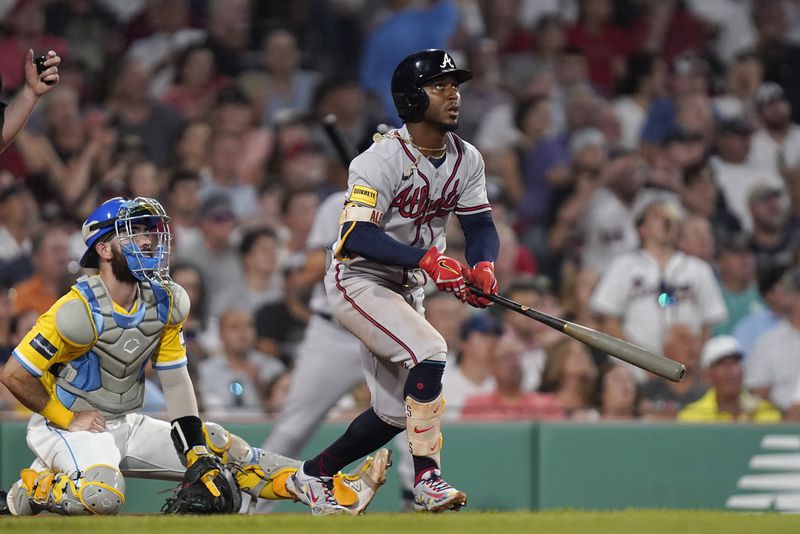 Atlanta Braves' Ozzie Albies, right, watches the flight of his three-run home run as Boston Red Sox's Connor Wong, left, looks on in the sixth inning of a baseball game, Wednesday, July 26, 2023, in Boston. (AP Photo/Steven Senne)