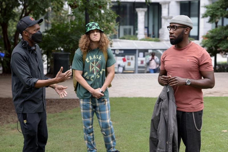 Woke -- “A Knight in the Park” - Episode 201 -- After a year of rising as a prominent activist, Keef draws a strip that sparks a protest headlined by him. But can he live up to his new platform? Director Maurice Marable, Gunther (Blake Anderson) and Keef Knight (Lamorne Morris), shown in downtown Atlanta, pretending to be San Francisco. (Photo by: Steve Swisher/Hulu)