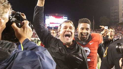 Georgia head coach Kirby Smart and defensive back Maurice Smith, who intercepted a pass and returned it for a touchdown, celebrate a 13-7 victory over Auburn on Saturday, Nov. 12, 2016, in Athens. (Curtis Compton/ccompton@ajc.com)