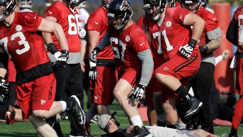 Falcons tackle Ryan Schraeder (73), guard Andy Levitre (67) and guard Wes Schweitzer (71) run through drills with teammates during a practice for the NFL Super Bowl 51 football game Thursday, Feb. 2, 2017, in Houston. (AP Photo/Eric Gay)