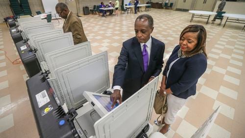 DeKalb CEO candidate Michael Thurmond, his wife Zola and DeKalb County Schools Superintendent Steve Green voted at Mt. Carmel Christian Church in Stone Mountain on Tuesday. JOHN SPINK / JSPINK@AJC.COM