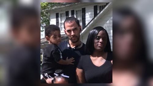 Anthony Dickerson holds his son, Anthony Jr., in a photo with the child's mother, Carmellia Burgess.
