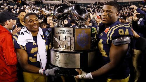 Navy midshipmen carrie off the Commander in Chief's trophy after defeating Army in an NCAA college football game, Saturday, Dec. 14, 2019, in Philadelphia. Navy won 31-7.  (AP Photo/Matt Rourke)