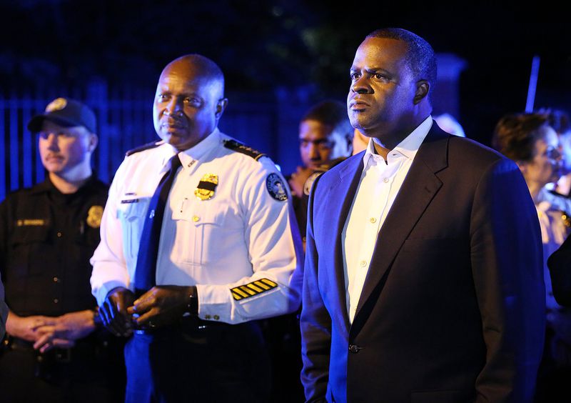 July 11: Mayor Kasim Reed and Police Chief George Turner stand in the street outside the Governor’s Mansion meeting with protesters during a fifth night of demonstrations. Curtis Compton /ccompton@ajc.com