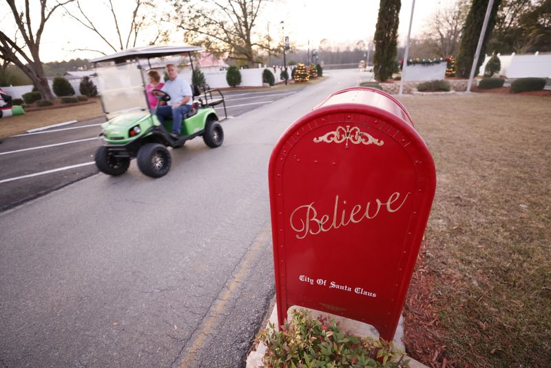 Some residents of Santa Claus, Ga., use golf carts and motorcycles to get around the tiny community. Visitors drop off stamped mail and letters to Santa at a red box outside city hall. The city's secretary inks a Santa Claus logo on the stamped mail and drops it off at the nearest post office in Lyons, Ga. 
 Miguel Martinez / miguel.martinezjimenez@ajc.com