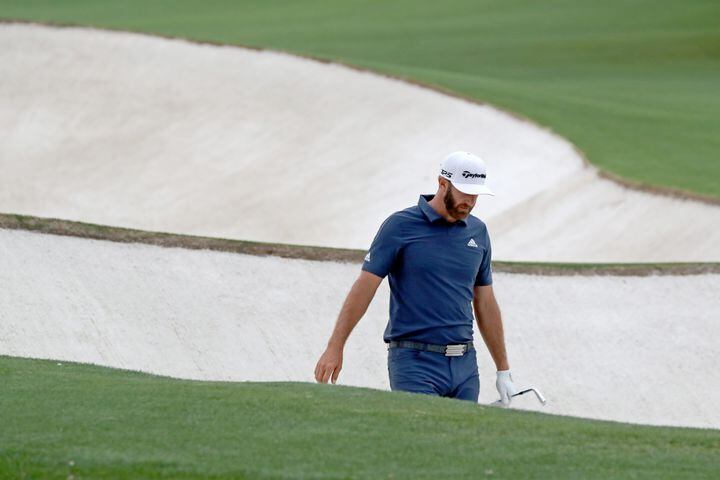April 9, 2021, Augusta: Dustin Johnson reacts after hitting into the fairway bunker on the eighteenth hole during the second round of the Masters at Augusta National Golf Club on Friday, April 9, 2021, in Augusta. Curtis Compton/ccompton@ajc.com