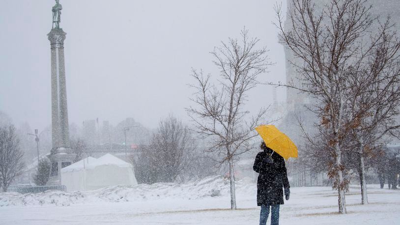 Sarah Wilson walks down the hill along Kellogg Avenue in St. Paul,. Minn., with an umbrella to shield the wind and snow last Monday. A blizzard warning was in effect for much of south central and southeastern Minnesota last week.