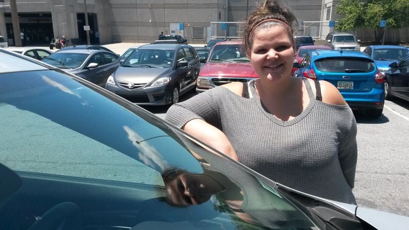 Kayce Ryan of Duluth recently started working as an Uber driver. She tried adding extras — like free bottled water and candy — to make passengers comfortable. She hopes it also leads to gratuities. MATT KEMPNER / AJC