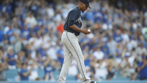 Atlanta Braves starting pitcher Julio Teheran reacts after Los Angeles Dodgers' Chase Utley hit a solo home run during the third inning of a baseball game, Saturday, July 22, 2017, in Los Angeles. (AP Photo/Ryan Kang)