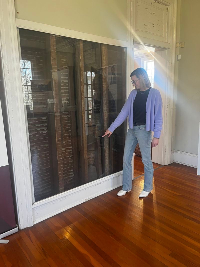 Chieftains Museum Executive Director Olivia Cawood displays a portion of the building’s original structure, which would have been visible during the time Cherokee leader Major Ridge owned the home.
(Elizabeth Crumbly for The Atlanta Journal-Constitution)