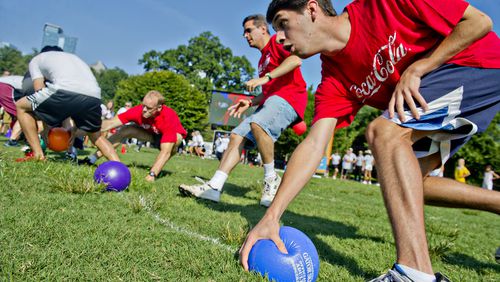 Players race to grab balls at the start of a game of dodgeball during the 2013 Boys & Girls Clubs of America's Day for Kids at Piedmont Park. Cobb County Parks is now beginning its first co-ed adult league.